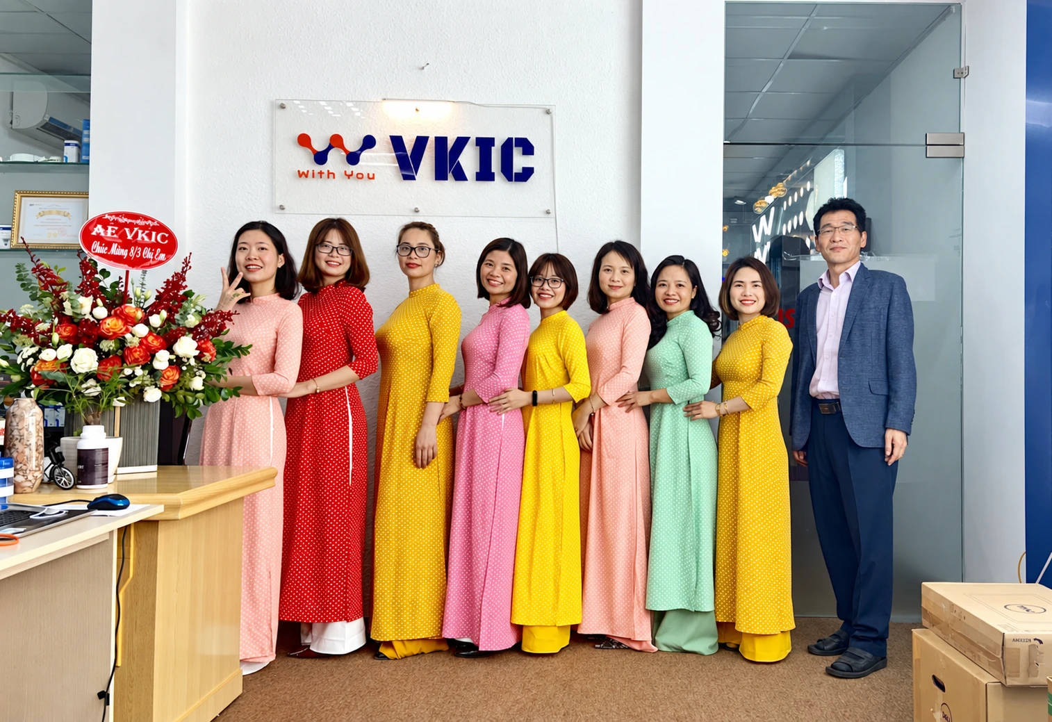 Women colleagues in colourful áo dài with the CEO at the VKIC office
